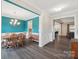 Dining room boasts a wooden dining set, blue accent walls, and elegant lighting at 3218 Gilroy Dr, Fort Mill, SC 29707