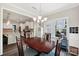Dining area with open view to kitchen, modern chandelier, and large windows at 3218 Gilroy Dr, Fort Mill, SC 29707