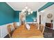 Dining room boasts a wooden dining set, blue accent walls, and elegant lighting at 3218 Gilroy Dr, Fort Mill, SC 29707