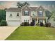 Charming two-story home featuring a well-maintained lawn, blue shutters, and a welcoming front entrance at 3218 Gilroy Dr, Fort Mill, SC 29707