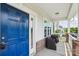 Close-up view of the porch with a blue door, brick columns, and outdoor seating at 3218 Gilroy Dr, Fort Mill, SC 29707