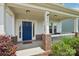 Charming front porch with a blue door, brick accents, and a 'hello' welcome mat at 3218 Gilroy Dr, Fort Mill, SC 29707
