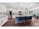 Bright kitchen features a central island with seating, stainless steel appliances, and ample counter space at 3218 Gilroy Dr, Fort Mill, SC 29707