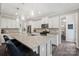 Modern kitchen boasts a large granite island, stainless steel appliances, and stylish pendant lighting at 3218 Gilroy Dr, Fort Mill, SC 29707