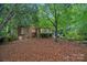 Secluded brick home featuring a large backyard shaded by mature trees and offering privacy at 3524 Rhett Butler Pl, Charlotte, NC 28270