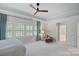 Bright main bedroom featuring tray ceilings, neutral walls, and shuttered windows with curtains, allowing natural light at 3524 Rhett Butler Pl, Charlotte, NC 28270
