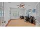 Well-lit office space with neutral walls, a ceiling fan, and hardwood floors with a jute rug at 3524 Rhett Butler Pl, Charlotte, NC 28270