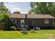 Charming backyard features a wooden deck and a green lawn with patio furniture at 386 Greenlea Cir, Taylorsville, NC 28681