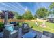 Spacious backyard featuring patio furniture, green lawn, and a wooden privacy fence at 386 Greenlea Cir, Taylorsville, NC 28681