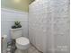 Cozy bathroom with decorative shower curtain and wood-style tile flooring at 386 Greenlea Cir, Taylorsville, NC 28681