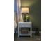 This bedroom features a stylish lamp, flowers, and decor with matching cowboy boots on the wood floor at 386 Greenlea Cir, Taylorsville, NC 28681
