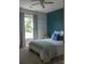This bedroom features a modern design with an accent wall, comfortable bedding, and plenty of natural light at 386 Greenlea Cir, Taylorsville, NC 28681