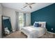 This bright bedroom features a modern design with an accent wall, comfortable bedding, and a stylish mirror at 386 Greenlea Cir, Taylorsville, NC 28681