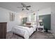 Cozy bedroom features stylish decor, a ceiling fan, wood floors and natural light from the window at 386 Greenlea Cir, Taylorsville, NC 28681