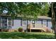 Well-maintained home featuring a quaint front porch with beautiful landscaping at 386 Greenlea Cir, Taylorsville, NC 28681