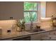 Bright kitchen sink area with granite counters, undermount sink and view to green outdoor scenery at 386 Greenlea Cir, Taylorsville, NC 28681
