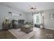 Comfortable living room setup with a cozy couch, area rug, and natural light coming through the window at 386 Greenlea Cir, Taylorsville, NC 28681