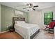 Cozy bedroom with a plush carpet, soothing green walls and an updated ceiling fan for comfort at 392 Tall Oaks Trl, Fort Mill, SC 29715