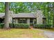Charming home featuring stone chimneys, neutral siding, trimmed hedges, and a mature tree shading the front yard at 392 Tall Oaks Trl, Fort Mill, SC 29715