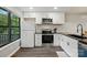 Updated kitchen featuring black countertops, white cabinets, and stainless steel appliances with natural light at 392 Tall Oaks Trl, Fort Mill, SC 29715