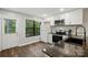 This light-filled kitchen offers white cabinets and stainless appliances at 392 Tall Oaks Trl, Fort Mill, SC 29715