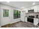 Kitchen area with white cabinets, stainless appliances, and a door to the outside at 392 Tall Oaks Trl, Fort Mill, SC 29715