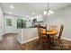 Bright eat-in kitchen with white cabinets, black counters and a breakfast table at 392 Tall Oaks Trl, Fort Mill, SC 29715