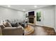 Inviting living room boasts wood floors, a stone fireplace, and natural light throughout at 392 Tall Oaks Trl, Fort Mill, SC 29715