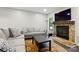 Bright living room with wood floors, neutral sofas, an accent rug, and a stone fireplace at 392 Tall Oaks Trl, Fort Mill, SC 29715