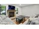 Inviting living room features a stone fireplace, wood flooring and natural light throughout at 392 Tall Oaks Trl, Fort Mill, SC 29715