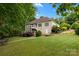 Exterior view of the property showcasing the home's spacious yard, mature trees, and outdoor living spaces at 400 Maymont Dr, Cramerton, NC 28032