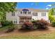 Exterior view of the home highlighting a spacious backyard with a patio, deck, and well-maintained landscaping at 400 Maymont Dr, Cramerton, NC 28032