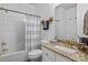 Bathroom with granite countertop vanity, a bathtub with shower, and neutral-toned fixtures at 400 Maymont Dr, Cramerton, NC 28032