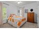 Comfortable bedroom featuring two windows, a dresser, and sports-themed decor at 400 Maymont Dr, Cramerton, NC 28032
