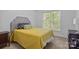Neutral bedroom with a tufted headboard, colorful pillows, and a window providing natural light at 400 Maymont Dr, Cramerton, NC 28032