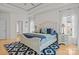 Spacious bedroom featuring a tray ceiling, plush bedding, white furniture and bright natural lighting at 400 Maymont Dr, Cramerton, NC 28032