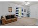 A versatile room featuring a couch, window, and shelving, creating a cozy and functional space at 400 Maymont Dr, Cramerton, NC 28032