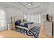 Bright bedroom featuring a tray ceiling, plush bedding, white furniture, and bright natural lighting at 400 Maymont Dr, Cramerton, NC 28032