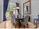 Formal dining room with a large window, elegant chandelier, and a statement mirror above the buffet at 400 Maymont Dr, Cramerton, NC 28032