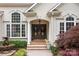 Charming front entrance featuring a double-door entry, decorative columns, and lush landscaping at 400 Maymont Dr, Cramerton, NC 28032
