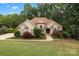 Charming single-Gathering home with well-manicured landscaping, mature trees, and a welcoming facade at 400 Maymont Dr, Cramerton, NC 28032