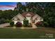 Stunning home featuring manicured landscaping, a charming fountain, and elegant architectural details at 400 Maymont Dr, Cramerton, NC 28032