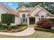 Inviting home exterior with a landscaped garden, a central fountain, and an elegant double-door entrance at 400 Maymont Dr, Cramerton, NC 28032