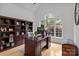 Bright home office with custom built-ins, a large window with a view, and hardwood flooring at 400 Maymont Dr, Cramerton, NC 28032