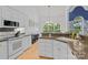 Open kitchen with granite counters, white cabinets, stainless steel appliances, and sun-filled eating nook at 400 Maymont Dr, Cramerton, NC 28032
