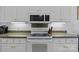 Kitchen appliances featuring a microwave, flat top stove, stainless steel appliances, and granite counters at 400 Maymont Dr, Cramerton, NC 28032