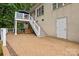 Spacious outdoor brick patio featuring staircase, white railings, covered seating area, and ample room for entertaining at 400 Maymont Dr, Cramerton, NC 28032