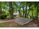 Stone patio nestled amongst mature trees at 400 Maymont Dr, Cramerton, NC 28032