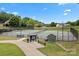 Well-maintained community tennis courts surrounded by lush landscaping and trees at 400 Maymont Dr, Cramerton, NC 28032
