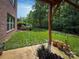 Lush backyard with a well-maintained lawn, surrounded by trees, and featuring a brick patio area at 4006 Tremont Dr, Indian Trail, NC 28079